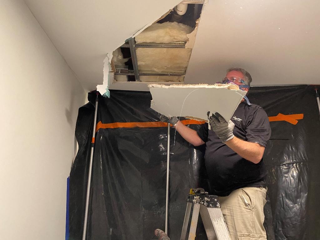 Sunspections remediation technician removing ceiling material